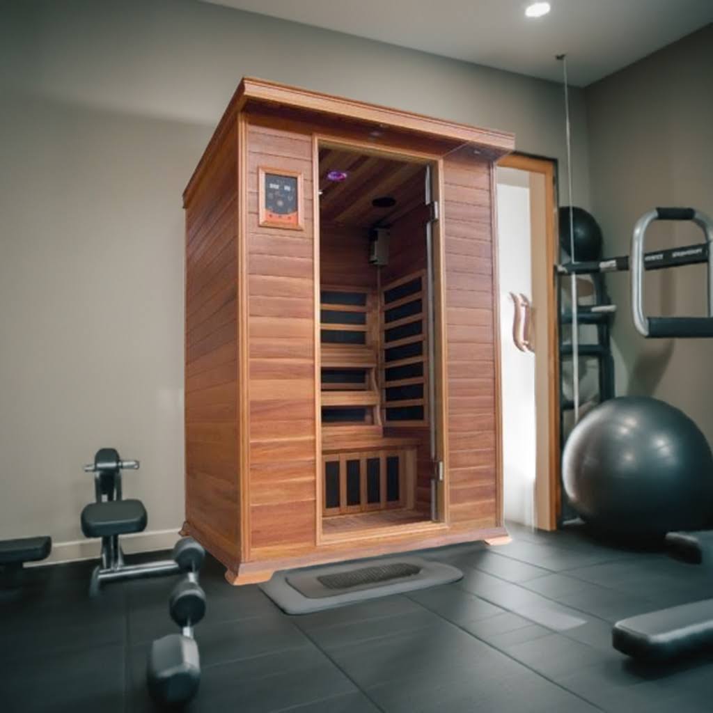 Wooden infrared sauna in a room with exercise equipment